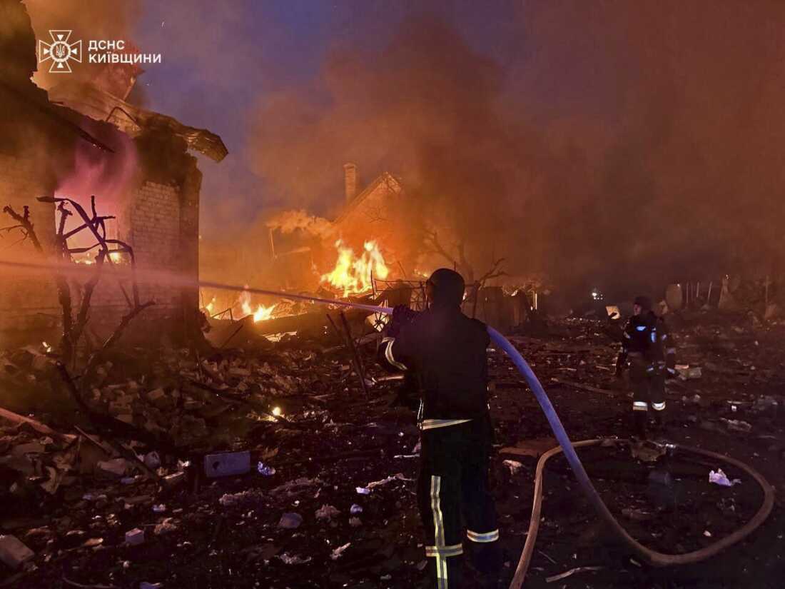 In this photo provided by the Ukrainian Emergency Service, firefighters try to put out a fire following a Russian attack in Kyiv region, Ukraine, Sunday, May 25, 2025. (Ukrainian Emergency Service via AP)