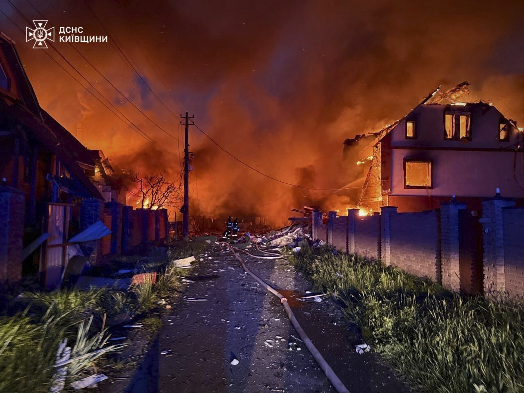 In this photo provided by the Ukrainian Emergency Service, firefighters try to put out a fire following a Russian attack in Kyiv region, Ukraine, Sunday, May 25, 2025. (Ukrainian Emergency Service via AP)