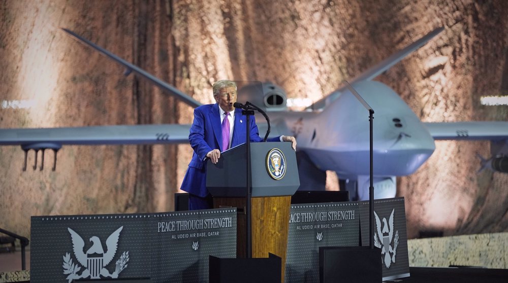 President Donald Trump speaks backdropped by an MQ-9 Reaper drone at the Al Udeid Air Base, Thursday, May 15, 2025, in Doha, Qatar. (AP Photo/Alex Brandon)