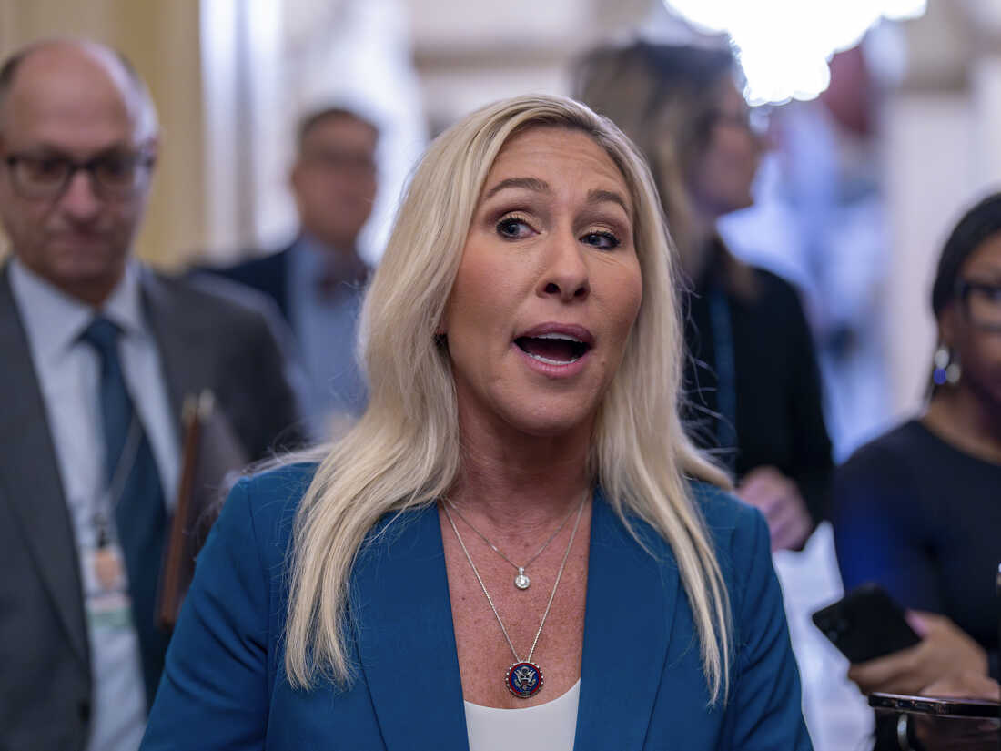 Rep. Marjorie Taylor Greene, R-Ga., talks to reporters after meeting privately with House Speaker Mike Johnson as he wrestles with a spending bill to fund the government, at the Capitol in Washington, Friday, Jan. 12, 2024. (AP Photo/J. Scott Applewhite)