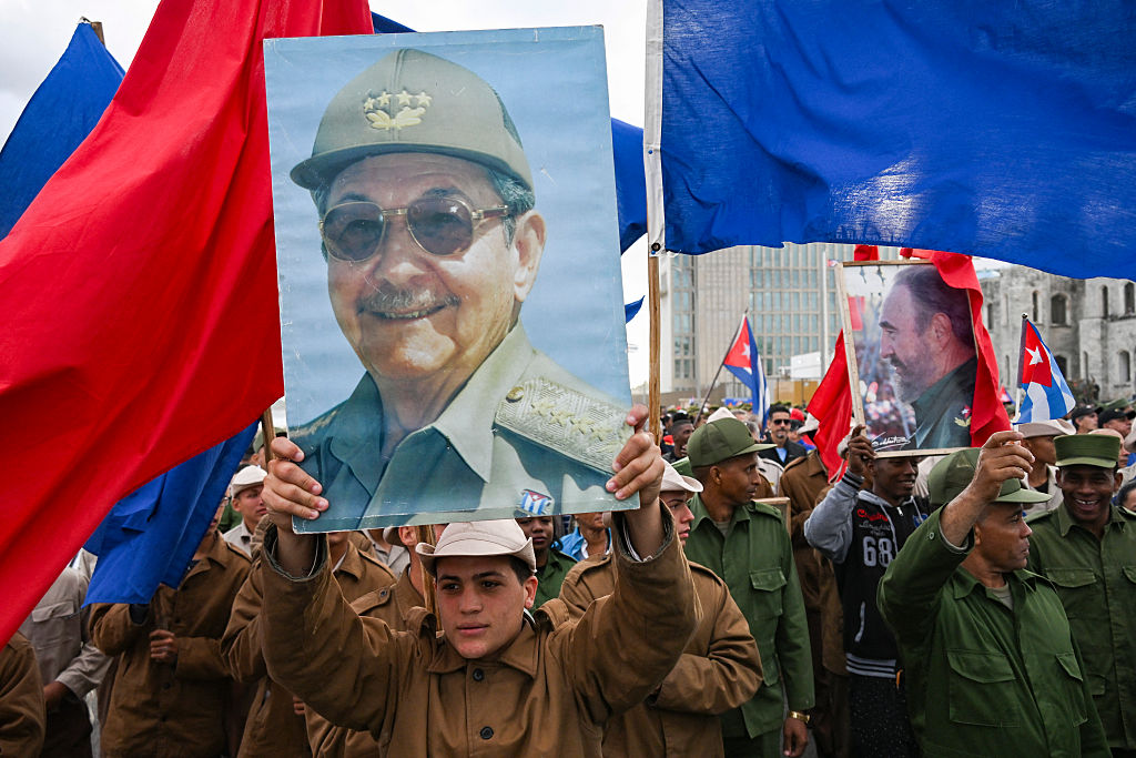 Members of the armed forces hold images of former Cuban president Raul Castro and the late Cuban leader Fidel Castro during an "Anti-Imperialist" protest in front of the US Embassy against the US incursion in Venezuela, where 32 Cuban soldiers lost their lives, in Havana on January 16, 2026. The capture by US forces of Venezuelan leader Nicolas Maduro on January 3, 2026, and the killing in the operation of 32 Cubans assigned to protect him represent a major blow for the island's revered intelligence services, experts say. (Photo by YAMIL LAGE / AFP)