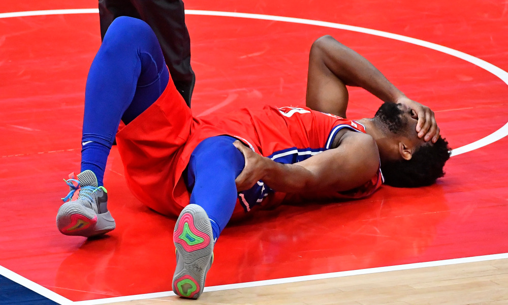 Mar 12, 2021; Washington, District of Columbia, USA; Philadelphia 76ers center Joel Embiid (21) reacts after suffering an apparent leg injury against the Washington Wizards during the third quarter at Capital One Arena. Mandatory Credit: Brad Mills-USA TODAY Sports