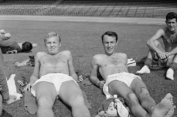 13th July 1966:  Bobby Moore (1941 - 1993) sunbathing with Jimmy Greaves (right) during the England team's pre-World Cup tour.  (Photo by Norman Quicke/Express/Getty Images)